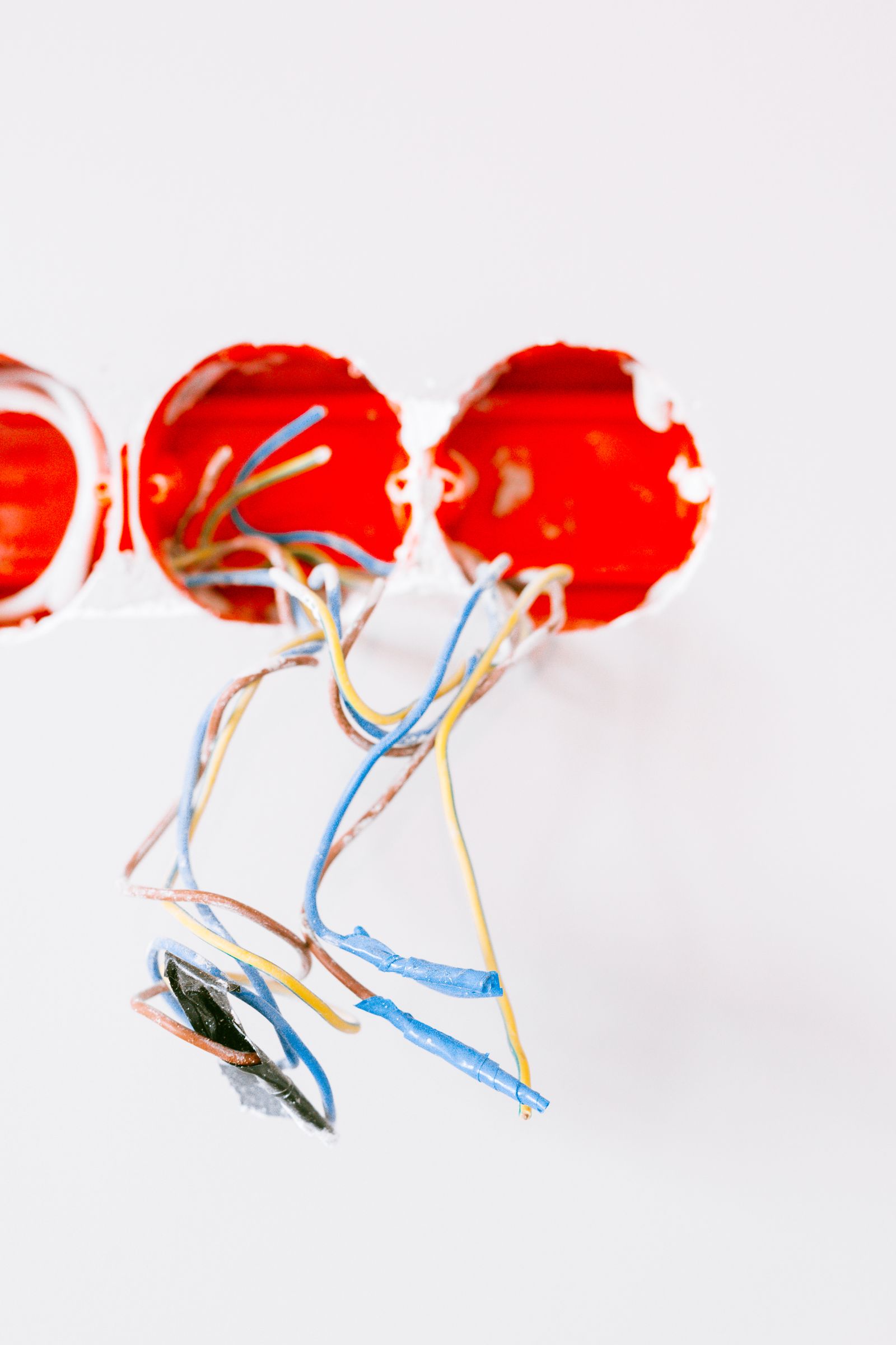 Sample image of wires coming out of red wall boxes in a white wall